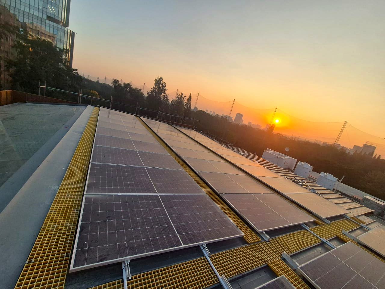Commercial rooftop solar array at sunrise in Bangalore