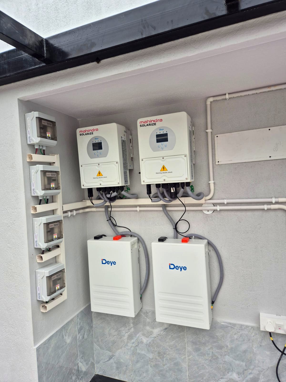 Licensed electrician working inside an electrical distribution panel