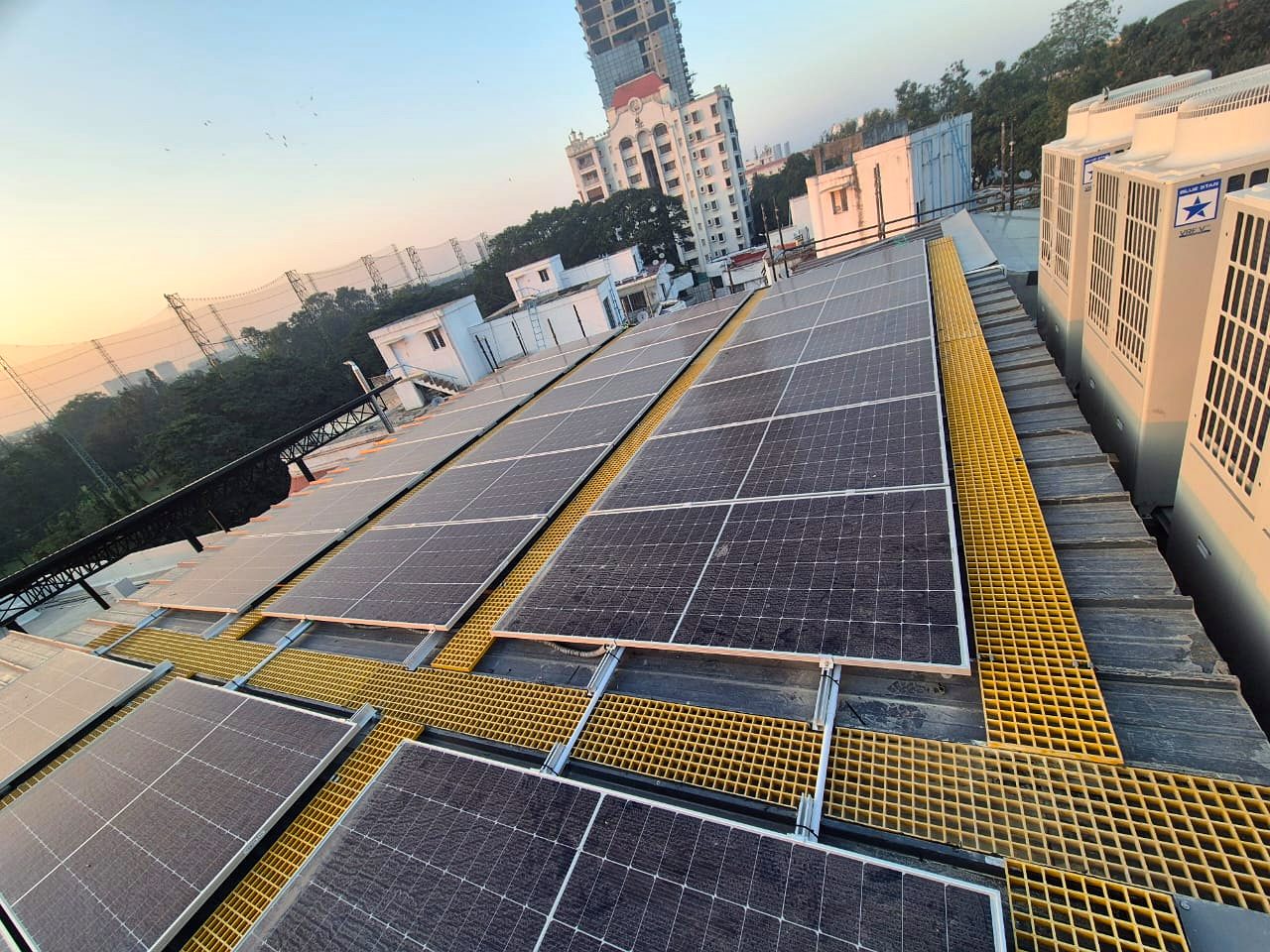 Rooftop solar array beside HVAC units in central Bangalore